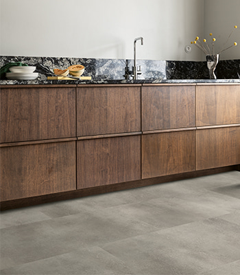 grey hybrid vinyl tile floor and a brown kitchen